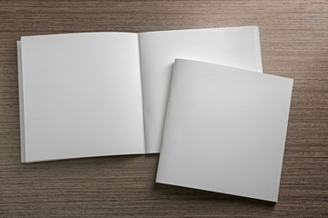 Blank brochures on wooden background