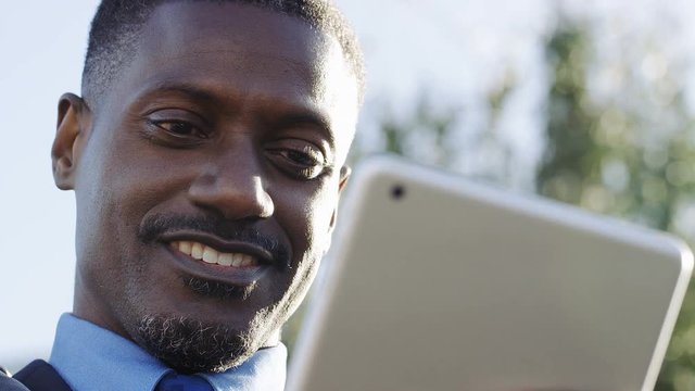 4K Handsome african american business man cheerfully using a digital tablet