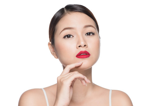 Beautiful asian woman with retro makeup with red lips isolated o