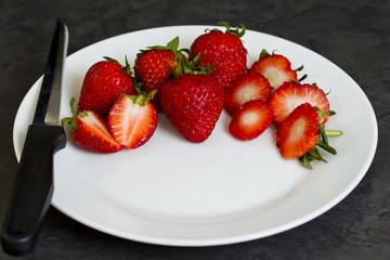 Sliced strawberries on a white plate