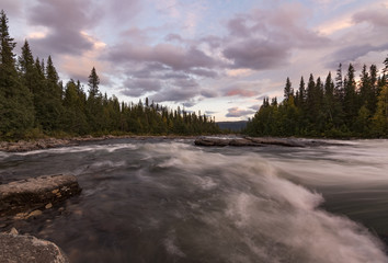 Pink river sunset in beautiful typical swedish landscape