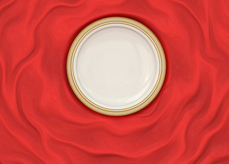 Empty round glazed plate with simple shiny frame on folded silk cloth.