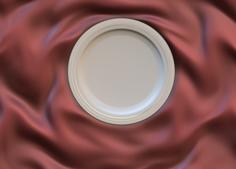 Empty round glazed plate with simple shiny frame on folded silk cloth.