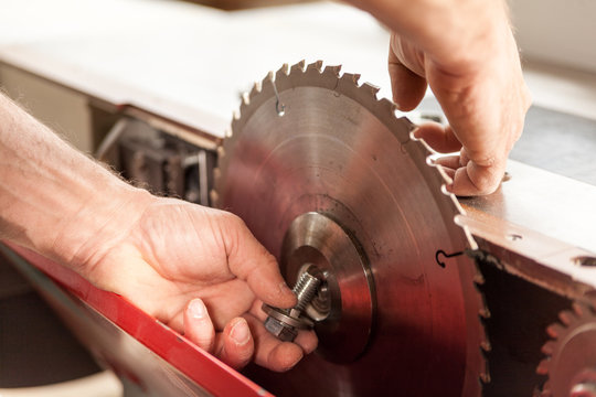 woodworker changing a sawblade by hand