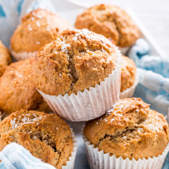 Delicious homemade coconut cinnamon muffins on old white tray. Healthy food concept.
