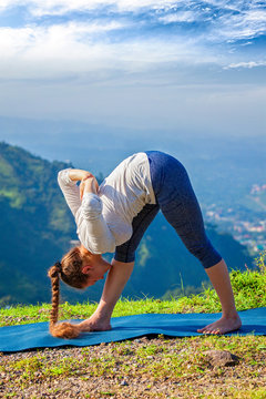 Woman doing Ashtanga Vinyasa yoga outdoors