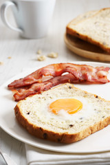 egg in a hole and crispy bacon