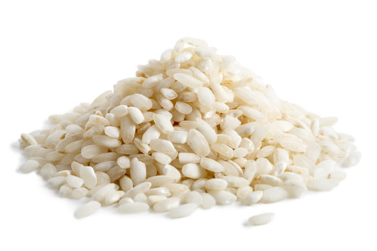 Pile of Arborio short grain white rice isolated on white.