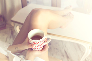 Obraz na płótnie Canvas tea time, relaxed woman drinking a tea at home