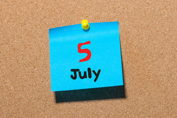 July 5th. Day 5 of month, color sticker calendar on notice board. Summer time. Close up