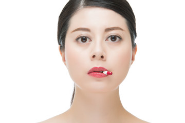 Fototapeta premium beautiful charming asian woman taking medicine pill for medical