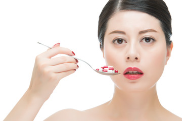 asian woman use spoon taking numerous of medicine pill
