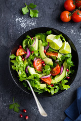 avocado, tomato and arugula salad. Healthy vegan food.