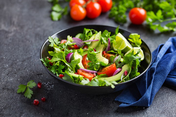 avocado, tomato and arugula salad. Healthy vegan food.