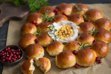 Holiday bread wreath with baked camembert,