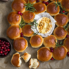 Holiday bread wreath with baked camembert,