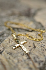 Golden cross on rock