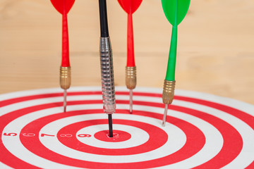 dart arrow and dartboard on wood background