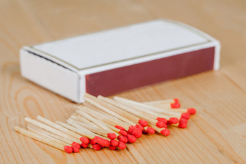 Matchsticks and box over wooden background
