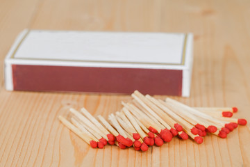 Matchsticks and box over wooden background