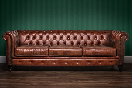 Brown Chesterfield Sofa With Green Wallpaper Background