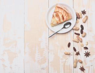 Slice of apple pie on vintage wooden background