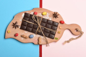 Dark chocolate bar on cutting board