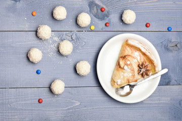 Slice of apple pie and coconut candies