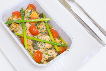 Salmon baked with tomato, capers and asparagus