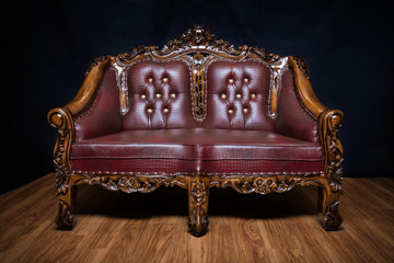 Dark brown leather royal chair with ornaments