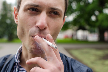 Young man smoking cigarette 