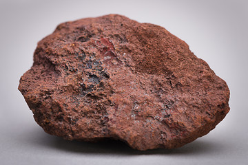 Natural sample of iron ore over gray background.