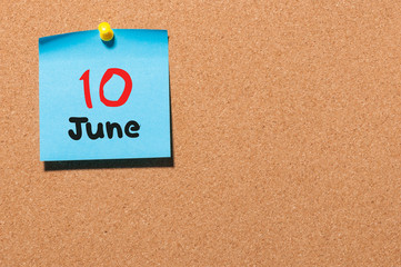 June 10th. Day 10 of month, color sticker calendar on notice board. Summer time. Empty space for text