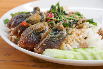Fried rice preserved egg and place on a plate.