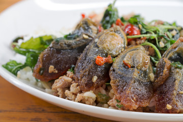 Fried rice preserved egg and place on a plate.