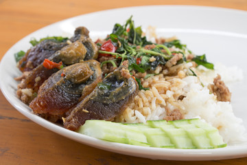 Fried rice preserved egg and place on a plate.