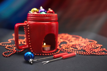 New Year's decor. The concept of the New Year holiday. Christmas decor. 2017. The drink. New Year, Christmas toys in a cup, fondue. Christmas background. New Year background. Red cup