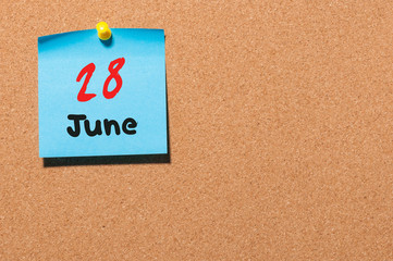 June 28th. Day 28 of month, color sticker calendar on notice board. Summer time. Empty space for text