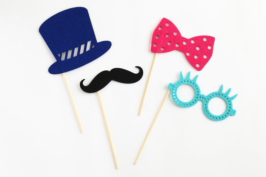 Photo booth colorful props for party - glasses, mustache, hat, ribbon on white background