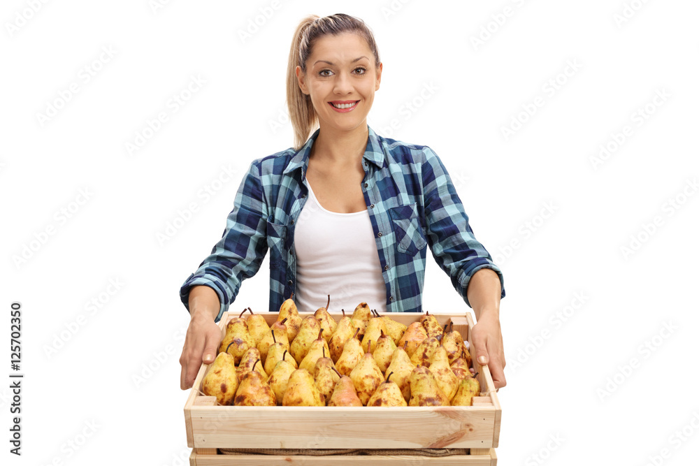 Poster Happy female farmer holding a crate full of pears