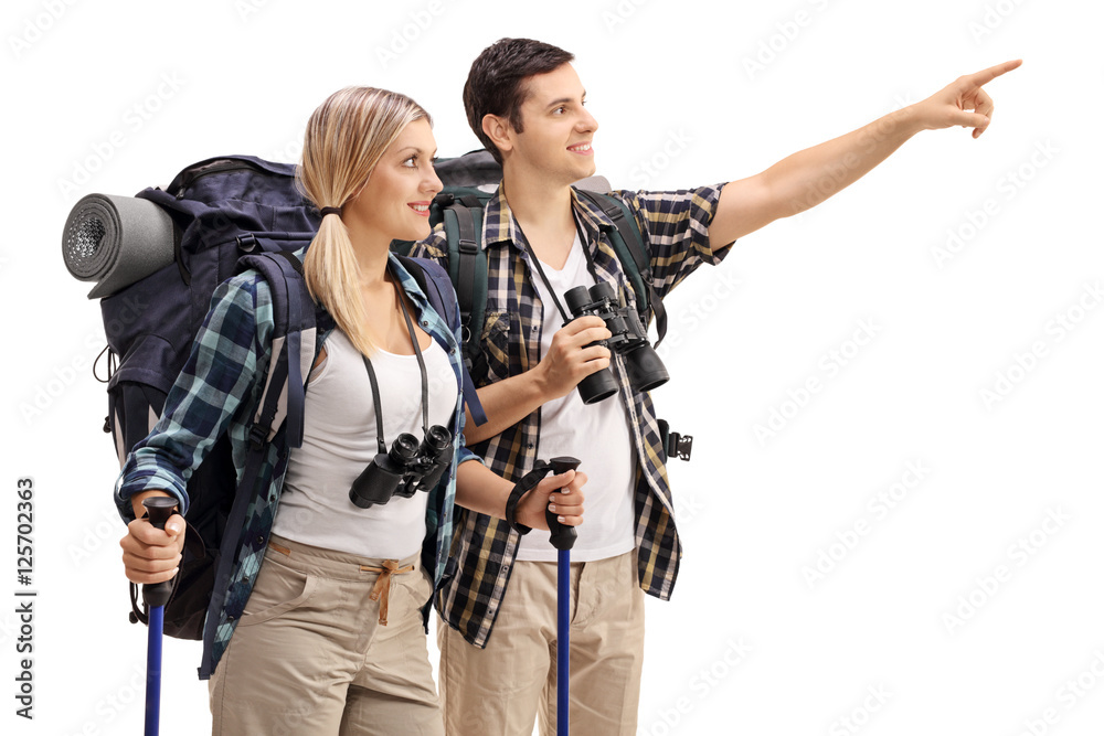 Sticker Male hiker showing something in the distance to female hiker