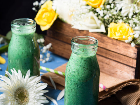Green smoothie in glass bottles