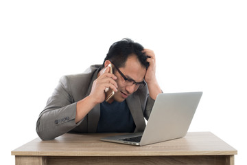 Stressed businessman talking on phone work  with laptop sitting