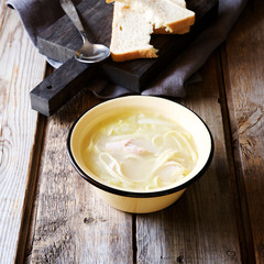 Chicken noodle soup in a rustic style 
