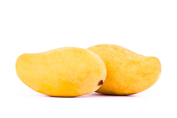 two yellow sweet ripe mango on white background healthy fruit food isolated
