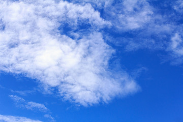 Blue sky background with white clouds. The vast blue sky and clouds sky on sunny day. White fluffy clouds in the blue sky.