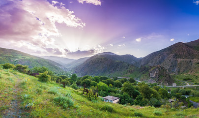 Fototapeta na wymiar Green meadow and blue sky with clouds. Exploring Armenia