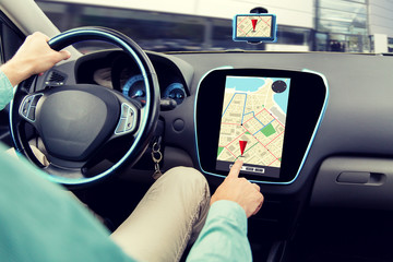 close up of man driving car and using navigator