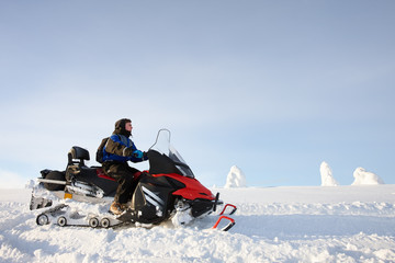 Man driving snowmobile in Finland