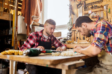 carpenters with ruler and blueprint at workshop